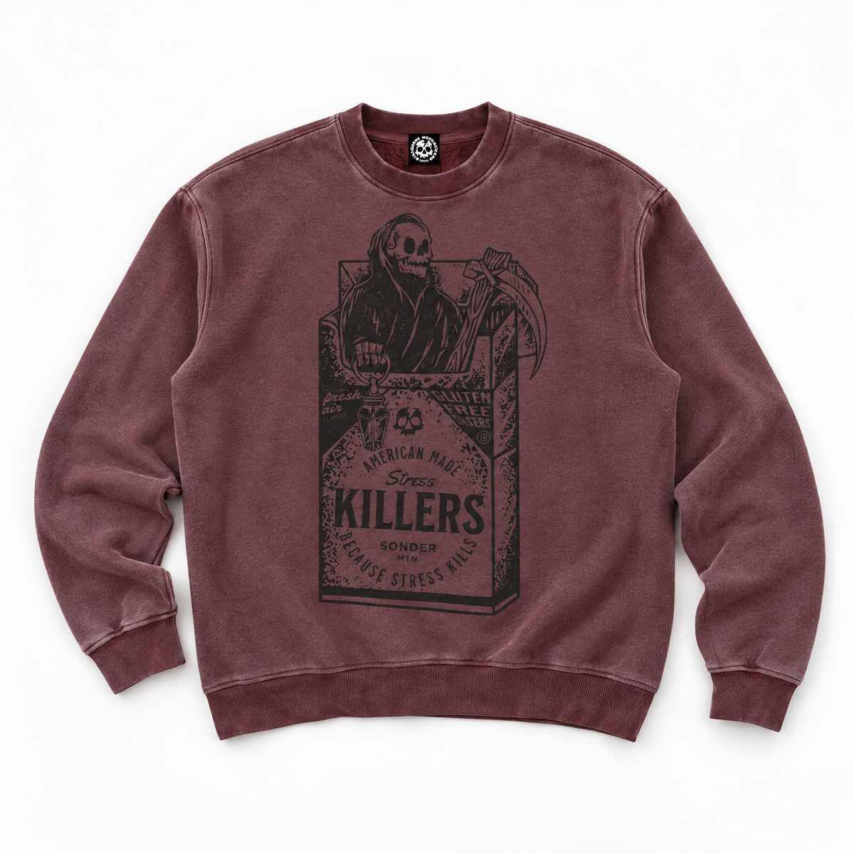 A washed burgundy crewneck sweatshirt featuring a large black graphic print of a skeleton in a suit holding a scythe, styled like a cigarette pack with the text 'KILLERS'.