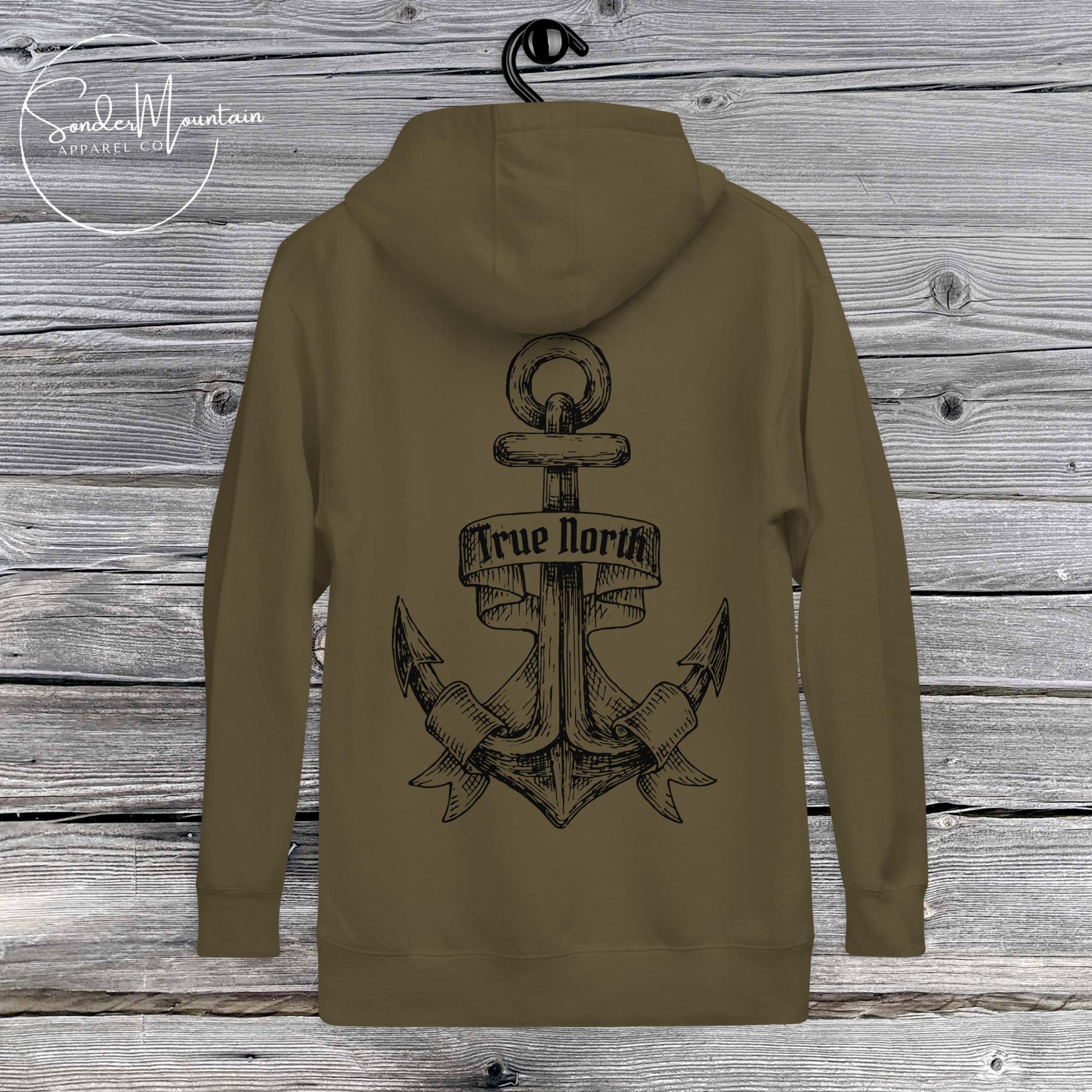 True North Tattoo-Inspired Unisex Hoodie with 100% cotton face, 65% ring-spun cotton and 35% polyester blend, bold anchor tattoo graphic on the back, “True North” emblem on the chest, front pouch pocket, matching flat drawstrings, 3-panel hood, and self-fabric patch on the back, crafted for durability, comfort, and meaningful streetwear style.