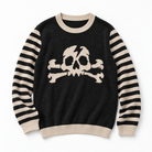 A black crewneck sweater with beige and black striped sleeves, featuring a large beige skull and crossbones graphic on the front, set against a plain white background.