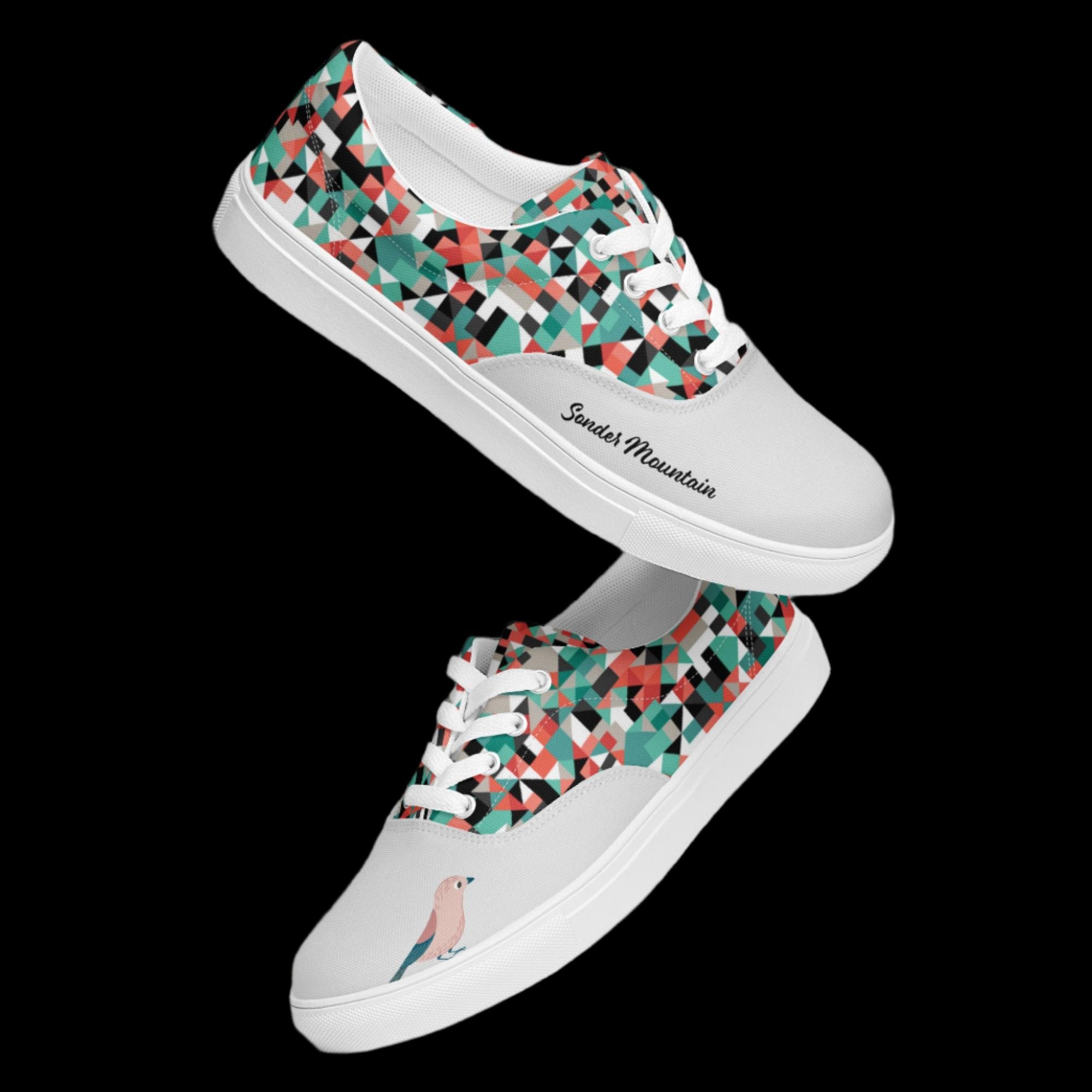 Sonder Mountain Little Bird Tattoo-Inspired Lace-Up Canvas Shoes with 100% polyester canvas upper, EVA rubber outsole, multicolor geometric design, signature tattoo-style bird graphic, breathable lining, padded collar and tongue, removable insole, and classic white laces, built for comfort, durability, and bold everyday streetwear style.