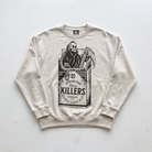 A cream-colored crewneck sweatshirt featuring a black graphic print of a skeleton in a cigarette pack labeled 'KILLERS'.