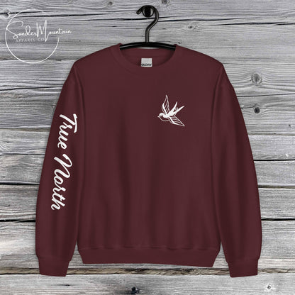 True North Mountain Classic tattoo-inspired unisex sweatshirt with 50% cotton and 50% polyester blend, pre-shrunk classic fit, air-jet spun soft low-pill fabric, 1x1 athletic rib-knit collar with spandex, double-needle stitched collar, shoulders, armholes, cuffs, and hem, bold sleeve typography and ink-inspired graphics, mission-driven streetwear designed for comfort, durability, and purposeful expression.